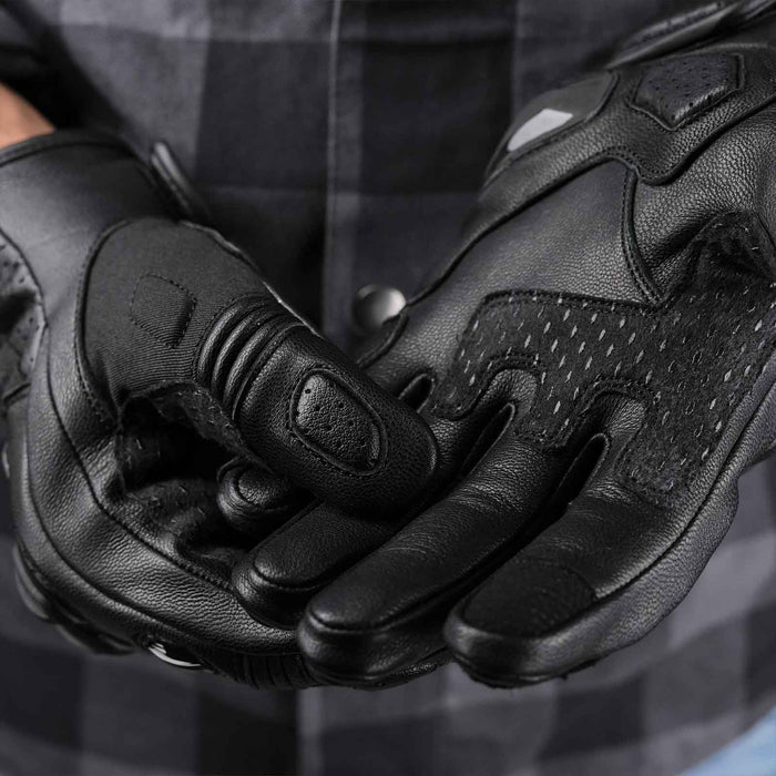 Leatherick CE certified men's black motorbike protective gloves showing reinforced palm padding and touchscreen-compatible fingertips worn with a grey checkered shirt.