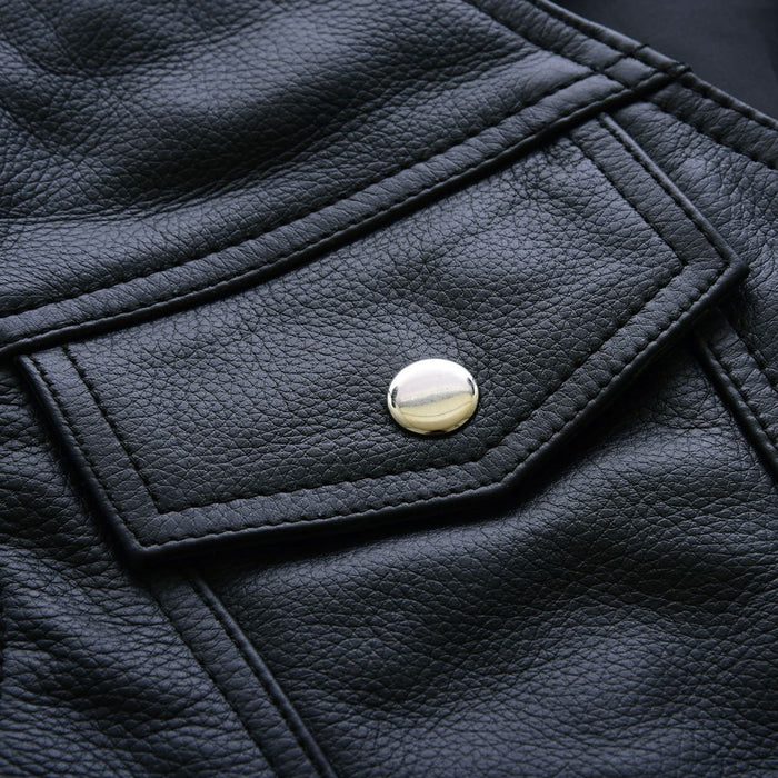 Detailed view of the chest pockets with leather flaps and brass snap closures.