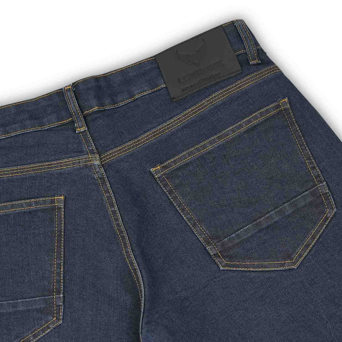 A close-up view of the rear pockets and back waistband of men's blue single-layer motorcycle riding jeans featuring a black branded leather patch.
